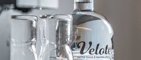 A Velote bottle and two glasses on a tray.