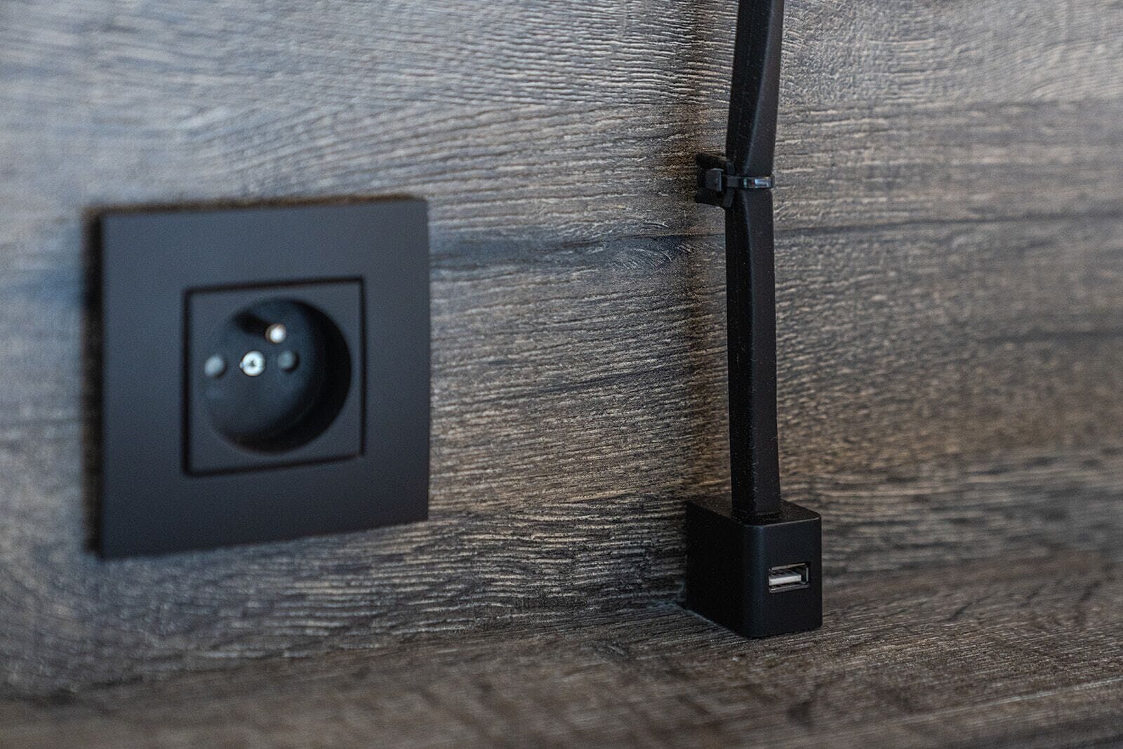 A wall-mounted electrical outlet with a USB port.