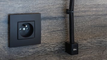 A wall-mounted electrical outlet with a USB port.