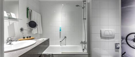 A modern bathroom with a bathtub, shower, and toilet.