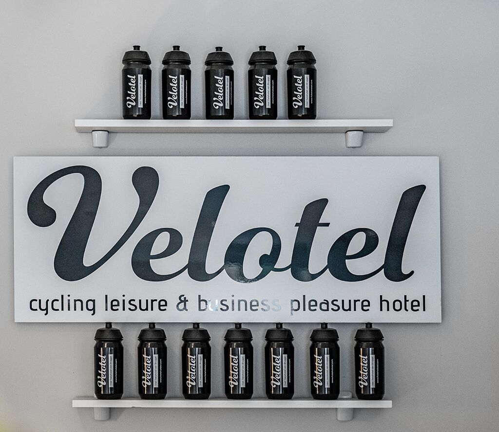 A Velotel sign with cycling and leisure amenities.