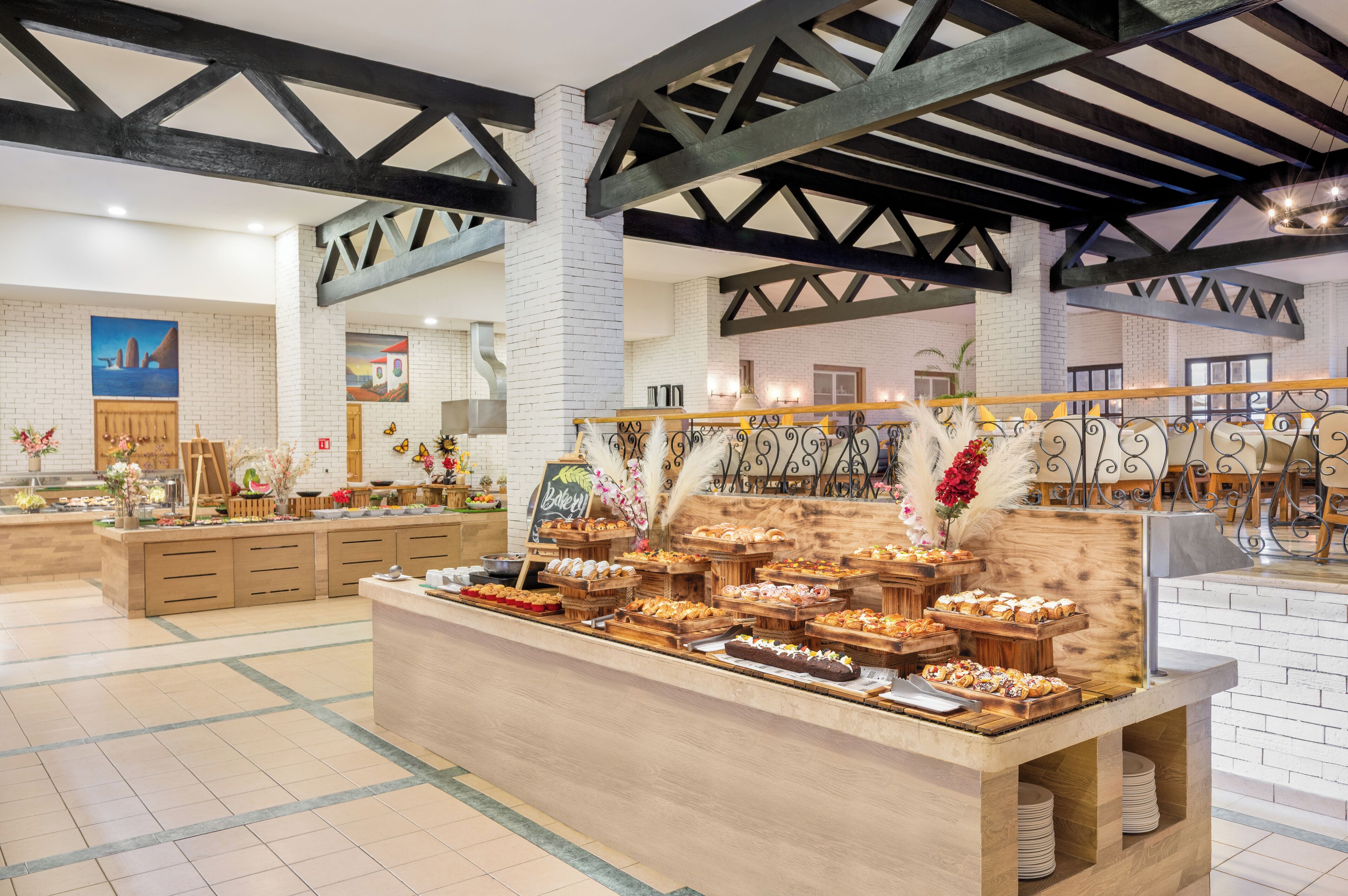 A bakery counter with various baked goods and a chalkboard sign.