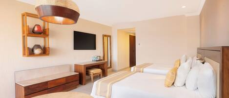 A hotel room with a bed, a desk, a chair, a television, and a hanging light fixture.