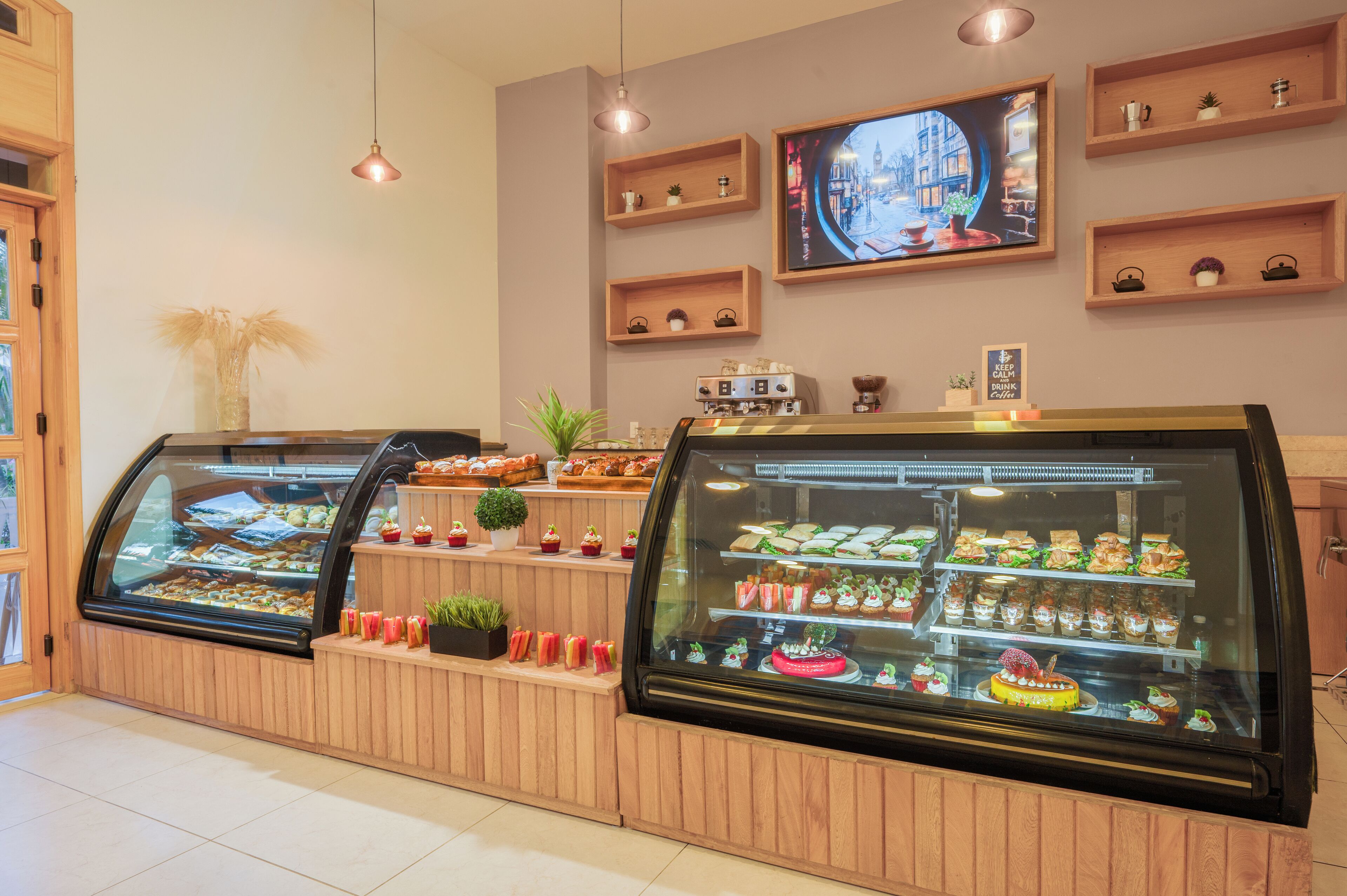 A bakery display case with various pastries and a coffee machine.