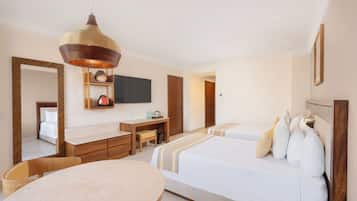 A hotel room with a bed, bedside table, chair, desk, and a television mounted on the wall.