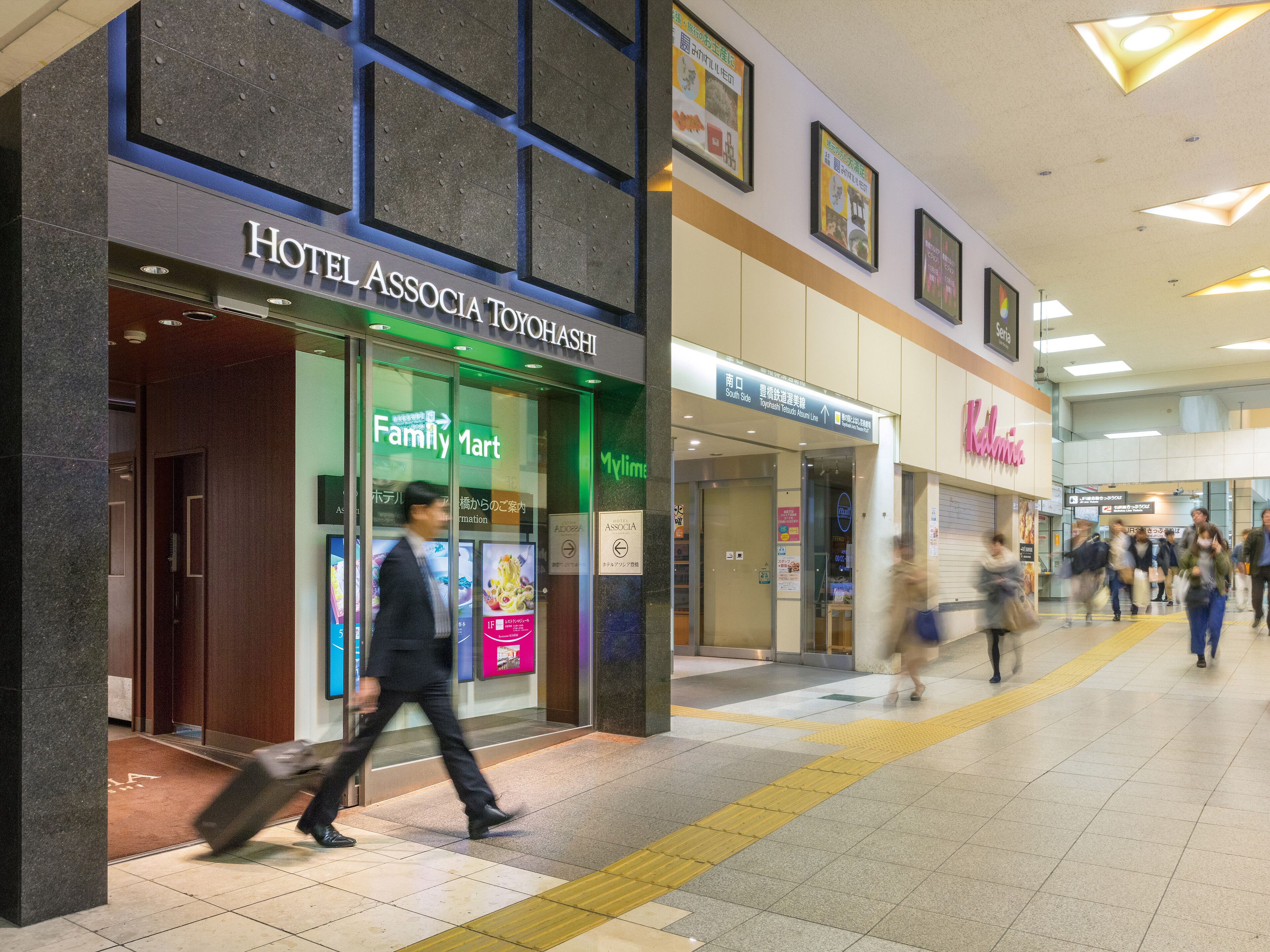 A hotel with a FamilyMart and a MyLyns store.