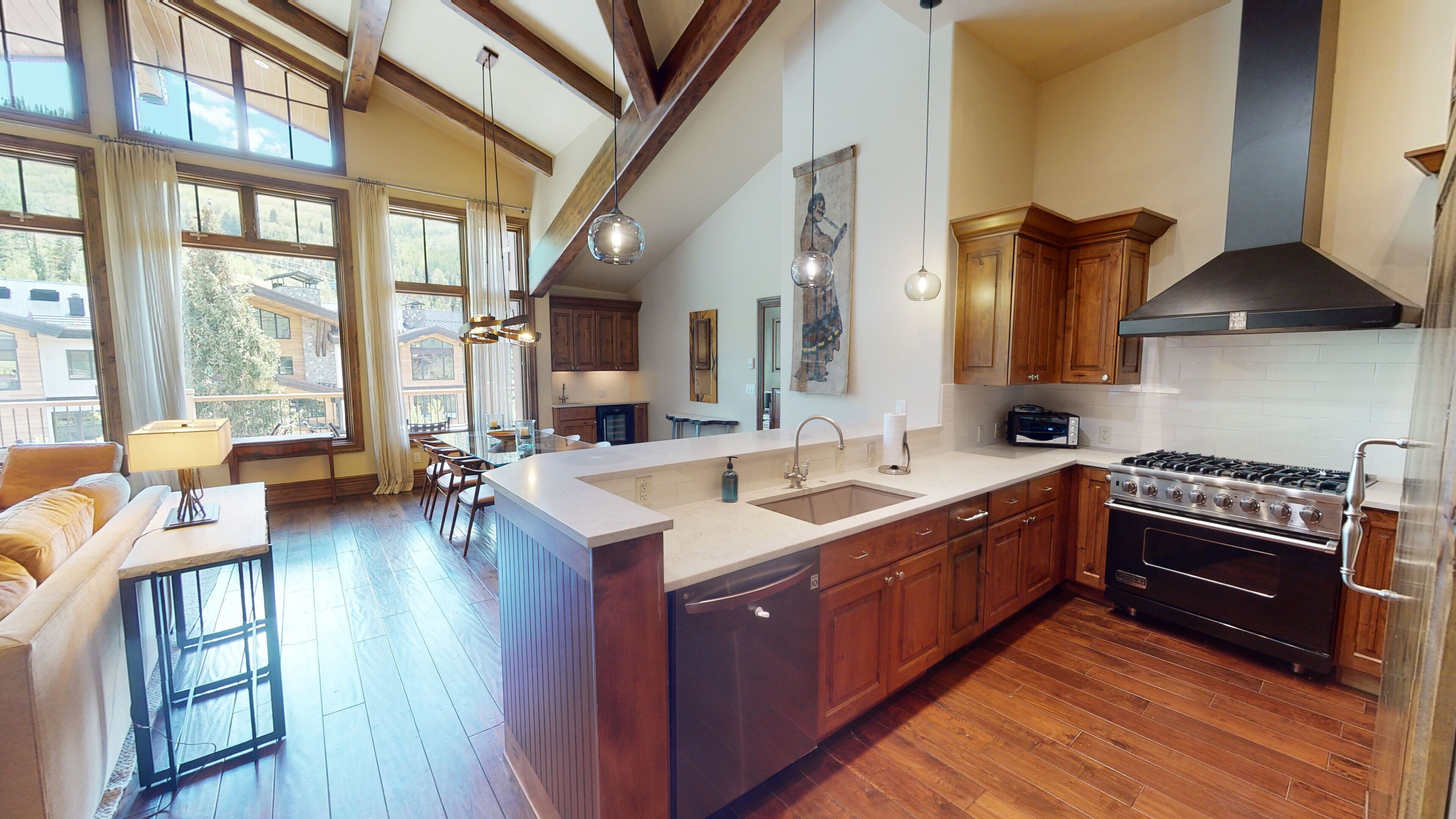 A spacious kitchen with a large island, wooden cabinets, and a built-in oven.