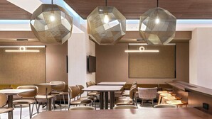 A modern dining area with hexagonal pendant lights, wooden tables, and upholstered chairs. - Springhill Suites By Marriott Denver Westminster (Westminster)