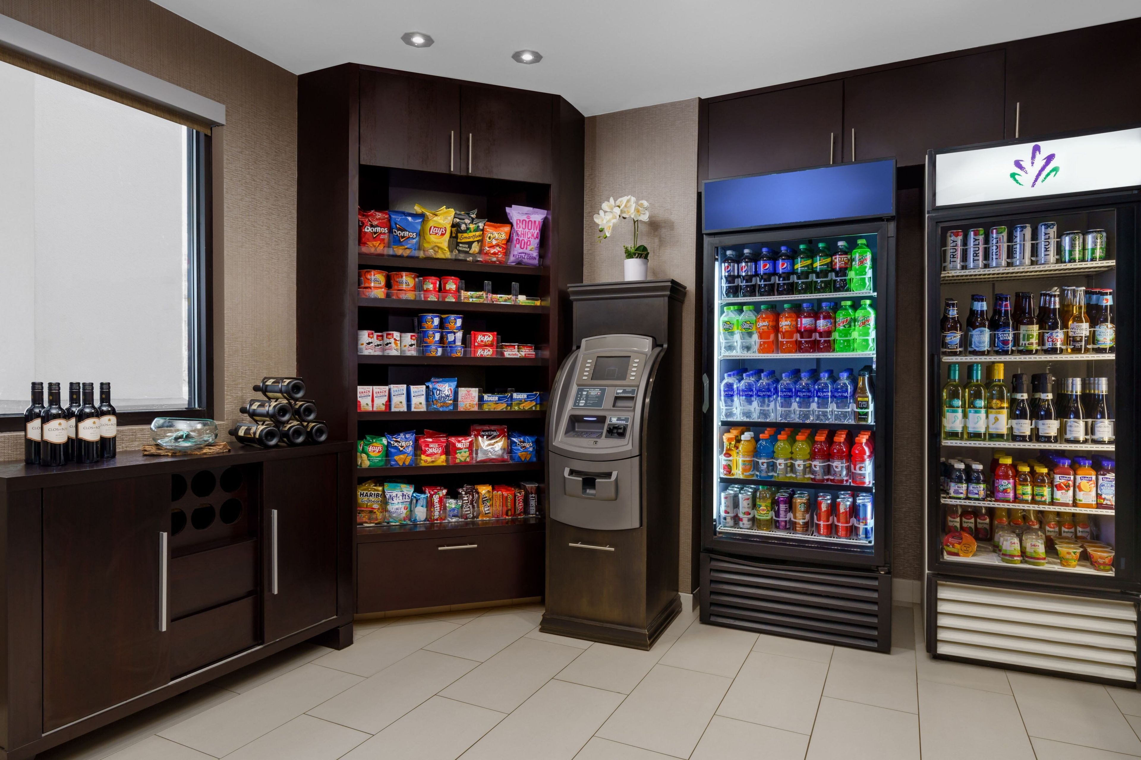 A self-service beverage station with a variety of drinks and snacks.
