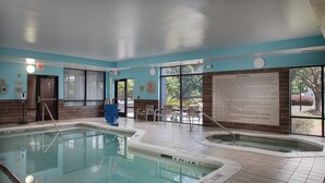 A pool area with clear signage, a lifeguard chair, and a spa safety notice. - SpringHill Suites by Marriott Savannah I-95 (Savannah)
