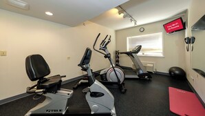 A gym with stationary bikes, a treadmill, and exercise balls. - Red Roof Inn & Suites Newburgh – Stewart Airport/ West Point (New Windsor)