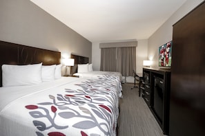 A hotel room with a large bed, a desk, a television, and a wardrobe. - Red Roof Inn & Suites Newburgh – Stewart Airport/ West Point (New Windsor)