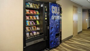A vending machine with snacks and a drink dispenser in a hotel corridor. - Red Roof Inn & Suites Newburgh – Stewart Airport/ West Point (New Windsor)