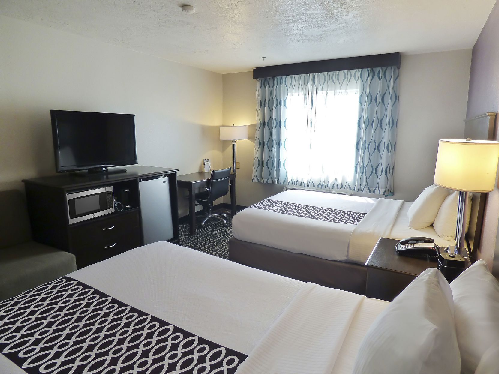 Premium bedding, pillowtop beds, desk, blackout drapes