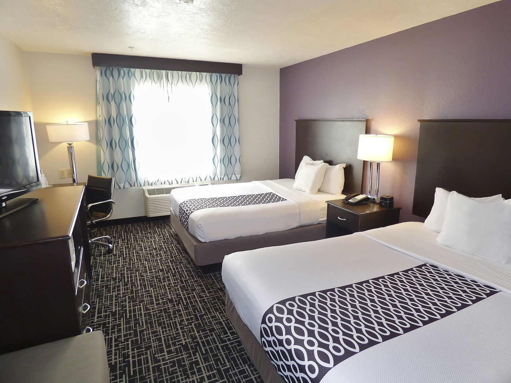 Premium bedding, pillowtop beds, desk, blackout drapes