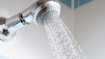 A showerhead with water flowing from it.