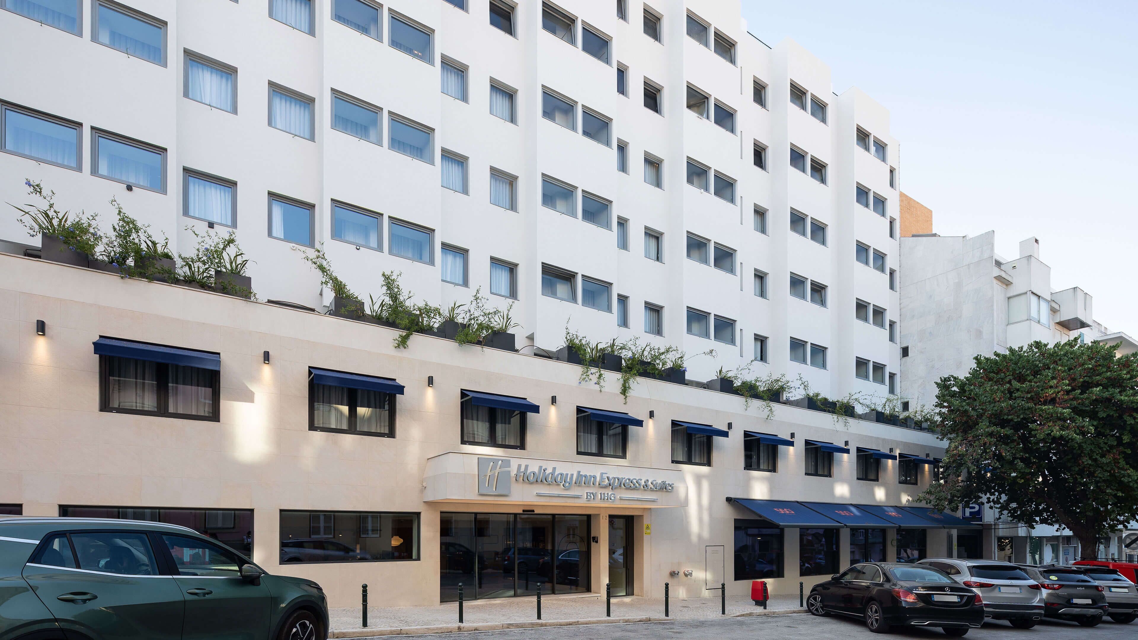 A multi-story hotel with a modern facade, large windows, and a Holiday Inn Express sign.