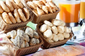 Baked goods are arranged in wicker baskets on a surface.