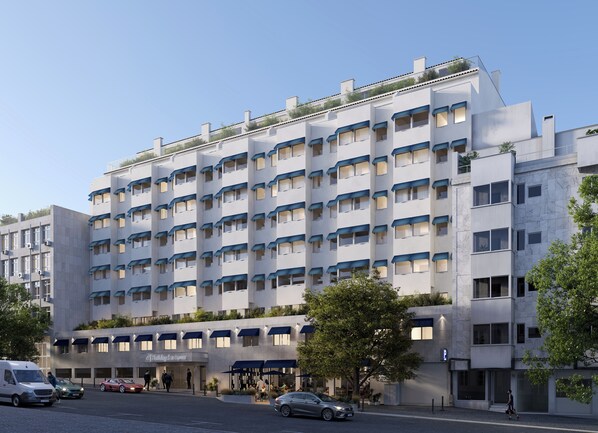 Hotel features a multi-story structure with balconies and a restaurant with outdoor seating.