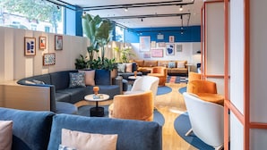 A modern lounge area with sofas, armchairs, and a coffee table. - Holiday Inn Express and Suites Lisbon Principe Real by IHG (Lisbon)