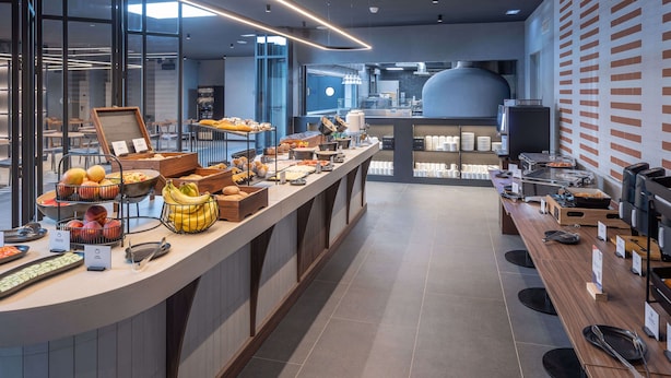 A modern breakfast buffet with various food items and a coffee station. - Holiday Inn Express and Suites Lisbon Principe Real by IHG (Lisbon)