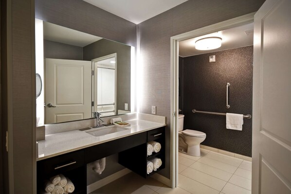 A modern bathroom with a large mirror, a sink, and a toilet. - DoubleTree by Hilton Deadwood at Cadillac Jack's (Deadwood)