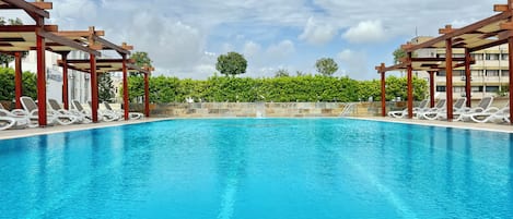 Seasonal outdoor pool, open 7:00 AM to 10:00 PM, pool umbrellas