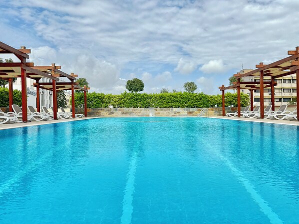 Seasonal outdoor pool, open 7:00 AM to 10:00 PM, pool umbrellas