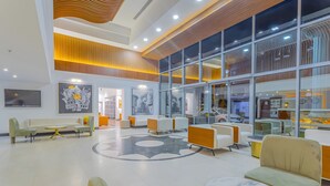 A spacious lobby with modern seating arrangements, a large glass wall, and a ceiling with wooden paneling. - Best Western Plus Khan Hotel (Antalya)