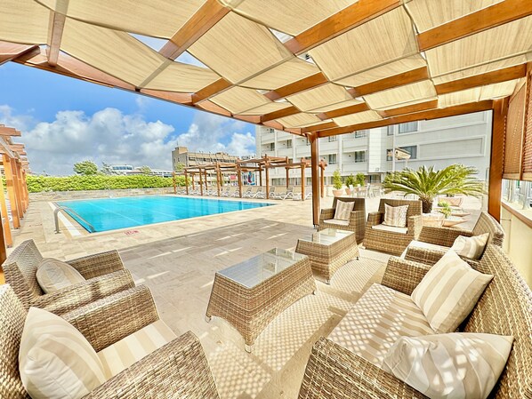 Seasonal outdoor pool, open 7:00 AM to 10:00 PM, pool umbrellas