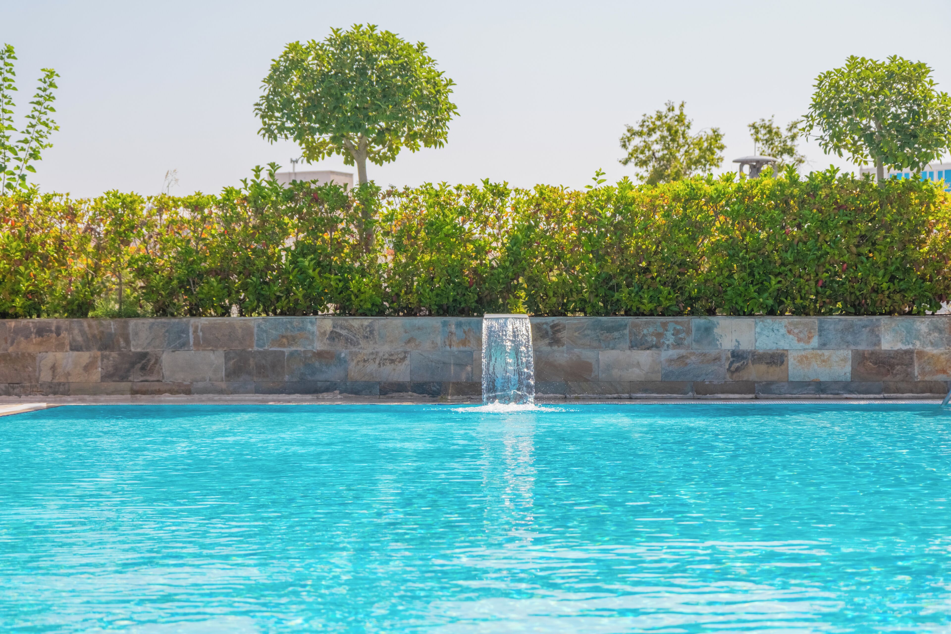 Seasonal outdoor pool, open 7:00 AM to 10:00 PM, pool umbrellas