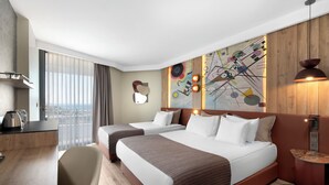 A hotel room with two beds, a desk, a chair, a large window with curtains, and a wall with abstract art. - Best Western Plus Khan Hotel (Antalya)