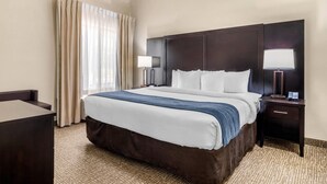 A hotel room with a large bed, two bedside tables with lamps, a desk, and a window with curtains. - Comfort Inn & Suites Atlanta/Smyrna (Smyrna)