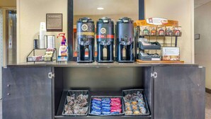 A coffee station with multiple coffee makers, a coffee dispenser, and a display of coffee pods. - Extended Stay America Suites Temecula Wine Country (Temecula)