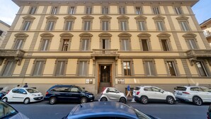 A multi-story building with a symmetrical facade, large windows, and a central entrance. - Hotel Annabella Roof Terrace (Florence)
