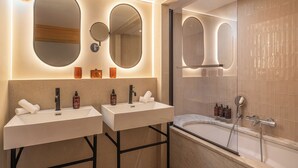 A modern bathroom with two sinks, a large mirror, and a walk-in shower. - Maison Honnel (Paris)
