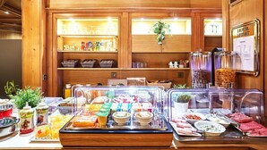 A buffet area with various food options, including fruits, vegetables, and prepared dishes.