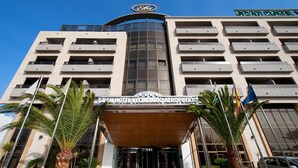 A hotel with a modern facade, multiple balconies, and a prominent entrance with a sign. - Elba Vecindario Aeropuerto Business & Convention Hotel (Santa Lucia)