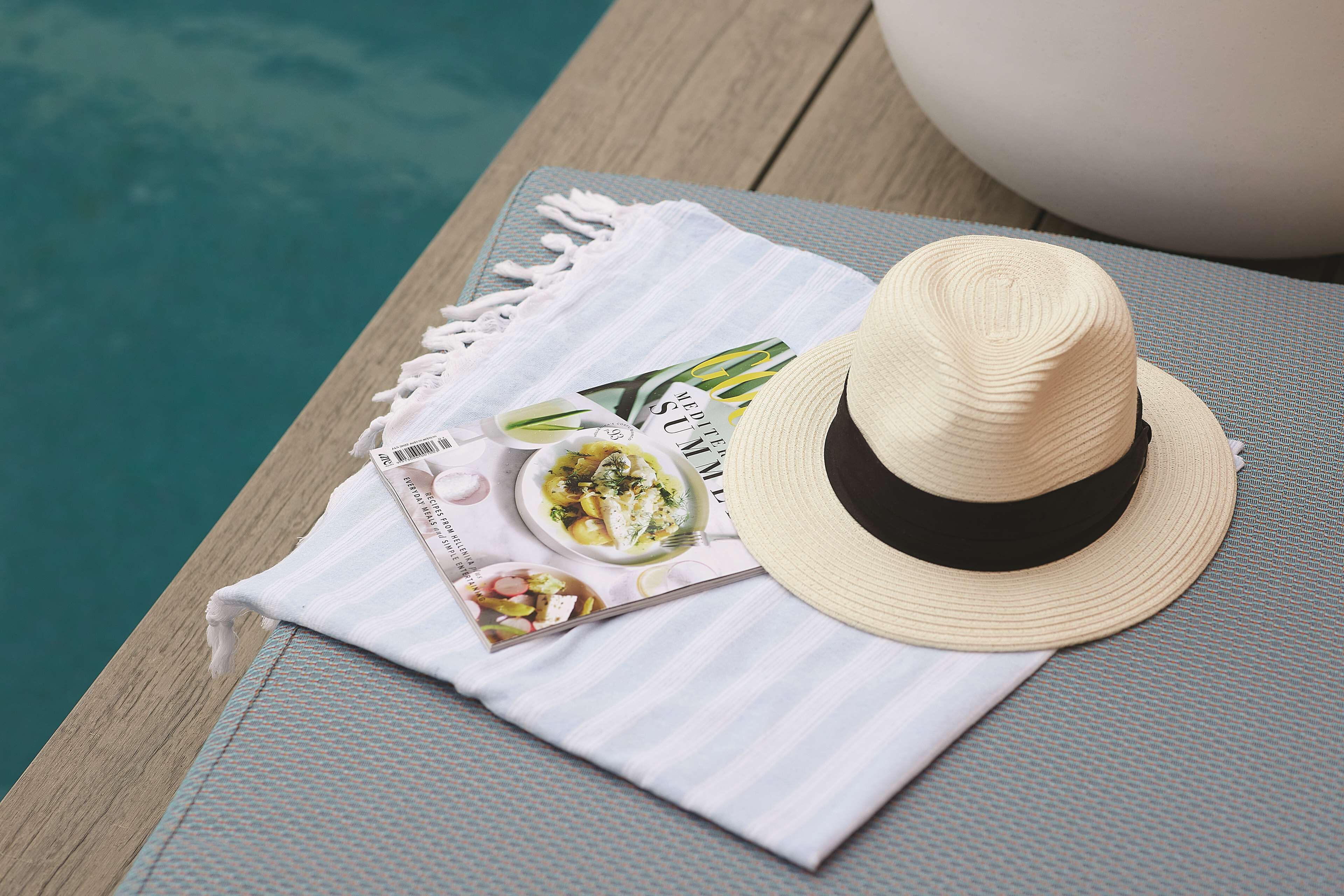 A dining area with a table set for a meal, a hat, and a menu.