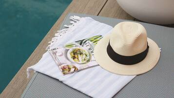 A dining area with a table set for a meal, a hat, and a menu.