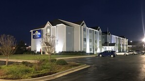 A multi-story hotel building with a prominent sign for the Wyndham Hotel. - Microtel Inn & Suites by Wyndham Meridian (Meridian)