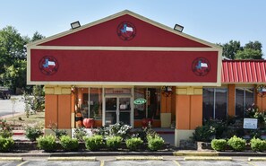 A building with a red roof and a sign indicating a lobby.