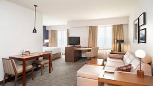 A hotel room with a bed, a desk, a sofa, a dining table, and a TV. - Residence Inn by Marriott New Bedford Dartmouth (North Dartmouth)