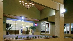 A hotel entrance with a modern light fixture above the door, a glass facade, and a signboard. - Mercure Jaraguá do Sul Hotel (Jaragua do Sul)