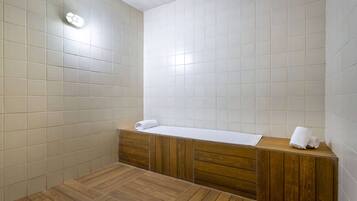 Bathroom features a minimalist design with a vanity, towel, and light fixture.