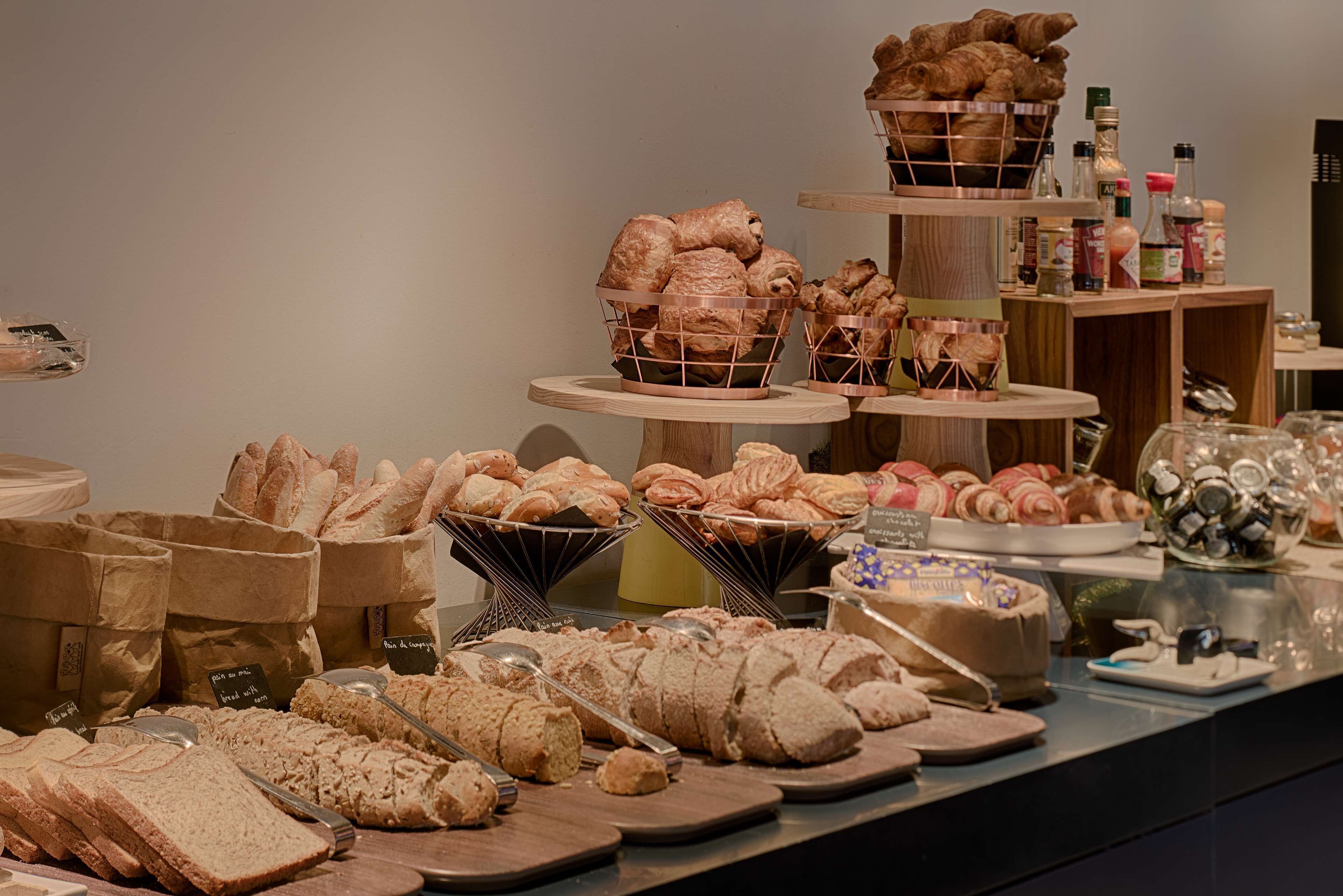 A bakery display with various breads and pastries.
