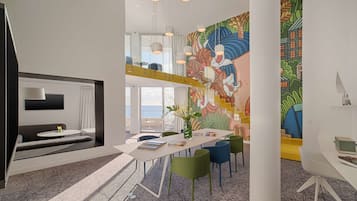 A modern interior with a dining area, colorful mural, and a view of the sea.