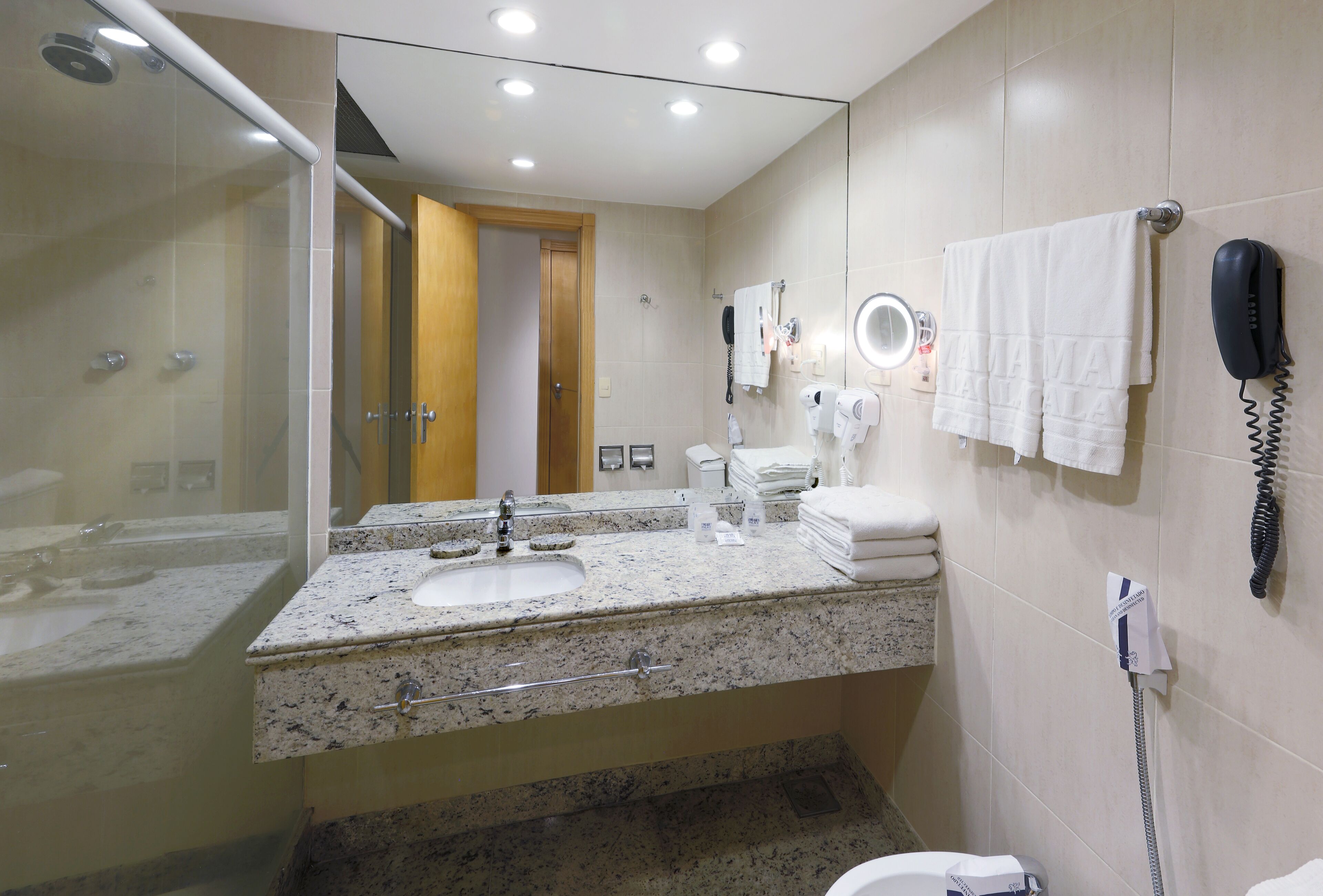 shower, hair dryer, towels, shampoo