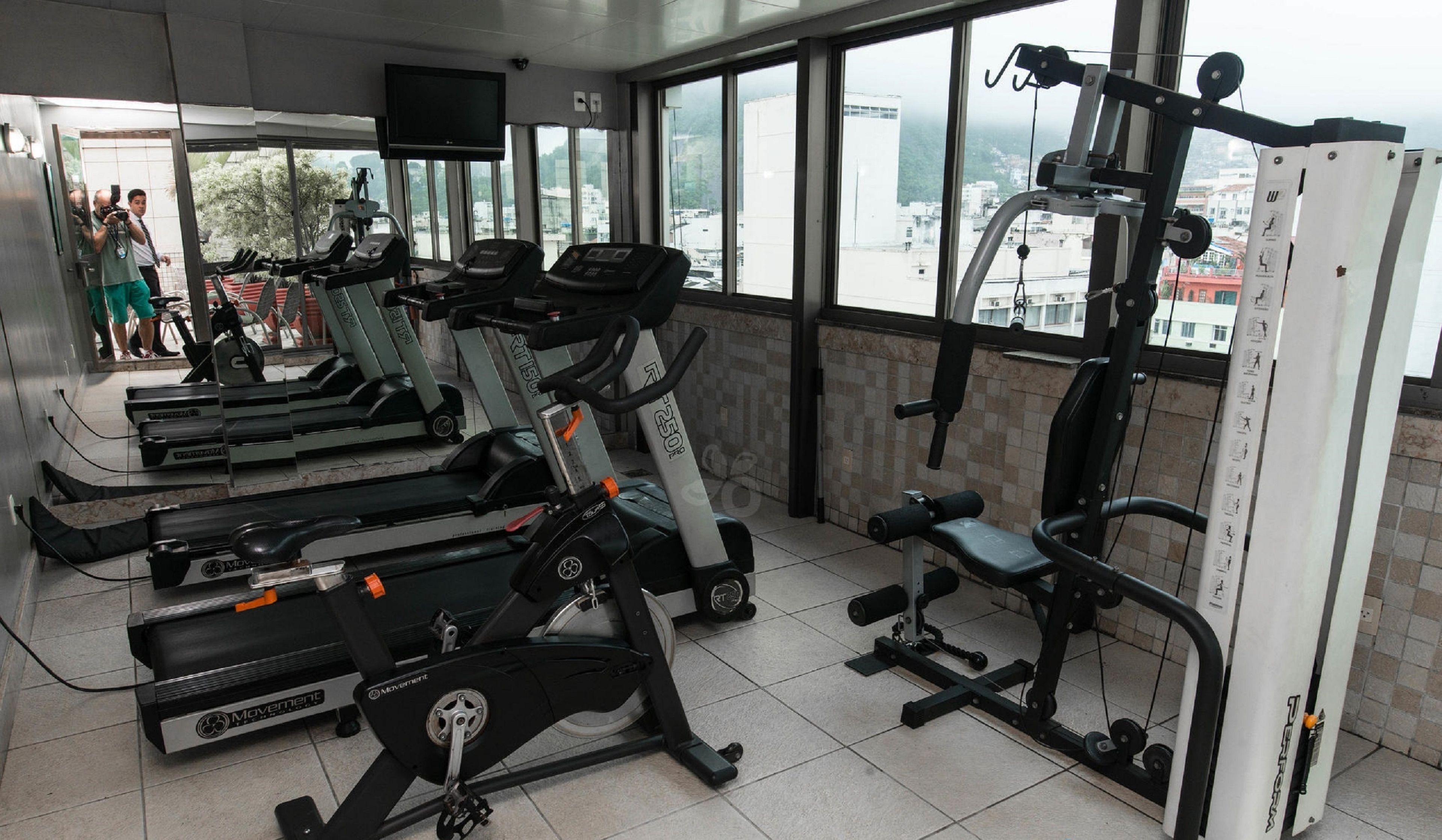 A gym with treadmills, an elliptical, and a weight machine.