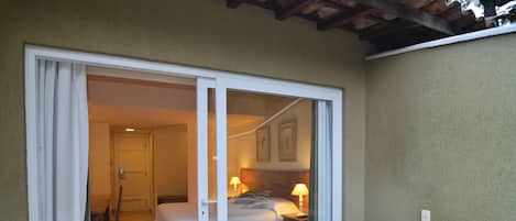A room with a bed, a wooden bench, and a bathtub.